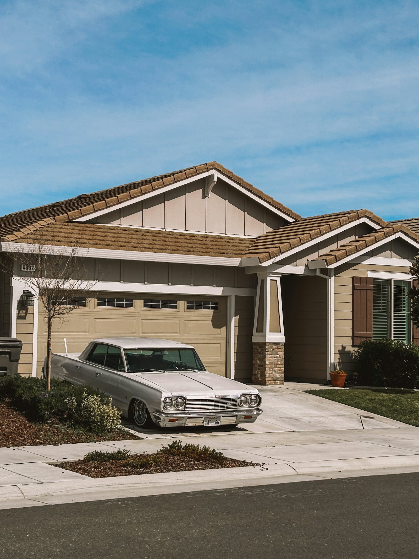 Station wagon parked near a suburban home